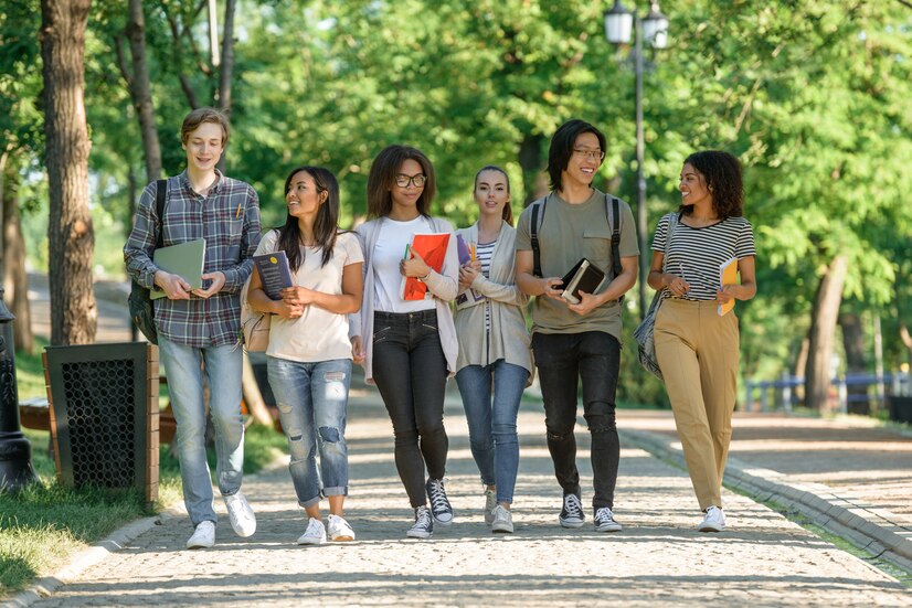 young-happy-students-walking-while-talking_171337-11708